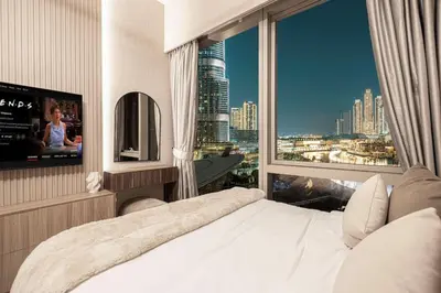 a bedroom with a large window with a view of a city at NEW YEARS Luxury Burj Khalifa and Fountain Views in Dubai