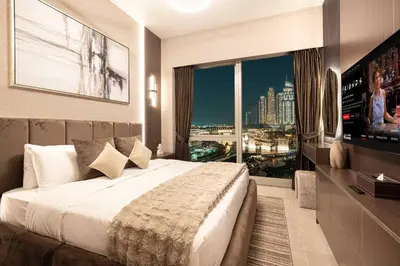 a bedroom with a large bed and a large window at NEW YEARS Luxury Burj Khalifa and Fountain Views in Dubai