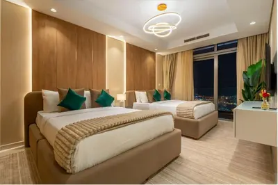 a hotel room with two beds and a couch at 5 Star Rooftop Infinity Pool with Burj Khalifa Views in Dubai