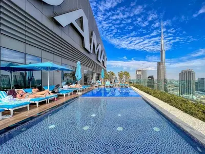 a hotel swimming pool on the roof of a building at 5 Star Rooftop Infinity Pool with Burj Khalifa Views in Dubai
