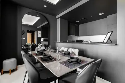 a dining room with a long table and chairs at 5 Star Rooftop Infinity Pool with Burj Khalifa Views in Dubai