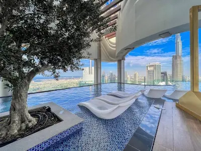 a pool with a tree in the middle of it at 5 Star Rooftop Infinity Pool with Burj Khalifa Views in Dubai