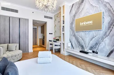 a living room with a couch and a tv at bnbmehomes - Oxford Terraces in Dubai