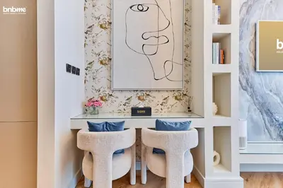 a home office with a desk and two stools at bnbmehomes - Oxford Terraces in Dubai