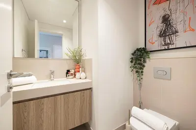 a bathroom with a sink and a mirror at Elite 4 Bedroom Luxury Apartment, Burj Khalifa View, Opposite Dubai Mall, Infinity Swimming Pool in Dubai