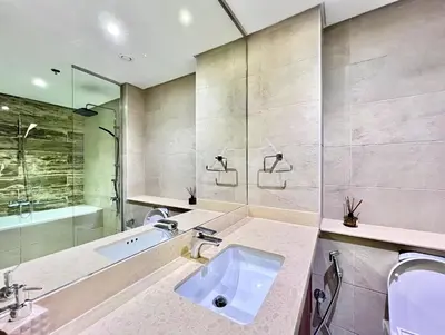a bathroom with a sink and a shower and a tub at Azizi Mina - Palm Jumeirah in Dubai