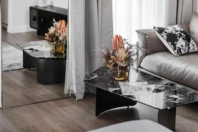 a living room with a couch and a glass table at Modern Stylish Studio Apartment next to Burj Khalifa walk into Dubai mall in Dubai