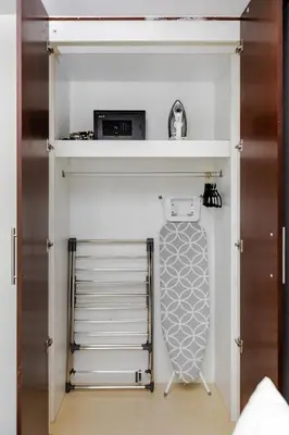 a room with a closet with a bed and a drawer at Modern Stylish Studio Apartment next to Burj Khalifa walk into Dubai mall in Dubai