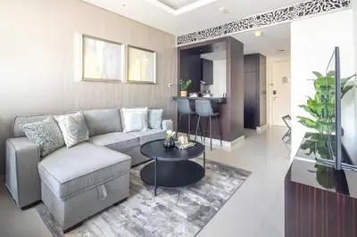 a living room with a couch and a table at Frank Porter - Damac Distinction in Dubai
