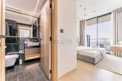 a bedroom with a bed and a bathroom at Close Proximity to Leisure Areas and City View 1BR, Binghatti Corner, Jumeirah Village Circle by Deluxe Holiday Homes in Dubai