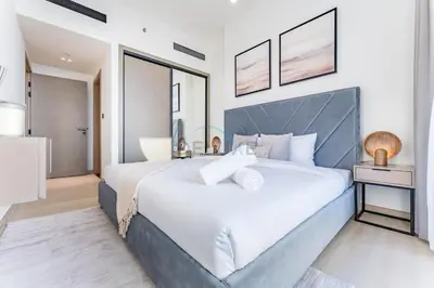 a bedroom with a large white bed and a mirror at Close Proximity to Leisure Areas and City View 1BR, Binghatti Corner, Jumeirah Village Circle by Deluxe Holiday Homes in Dubai