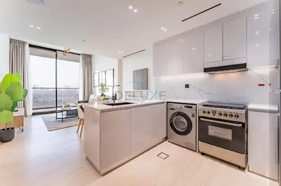 a kitchen with a stove and a dishwasher at Close Proximity to Leisure Areas and City View 1BR, Binghatti Corner, Jumeirah Village Circle by Deluxe Holiday Homes in Dubai
