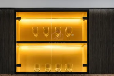 a set of wine glasses in a display case at Gorgeous 1BD Apt with beach access in Grand Bleu in Dubai