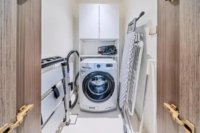 a laundry room with a washer and dryer at Gorgeous 1BD Apt with beach access in Grand Bleu in Dubai