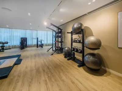 a gym with exercise equipment in a room at Gorgeous 1BD Apt with beach access in Grand Bleu in Dubai