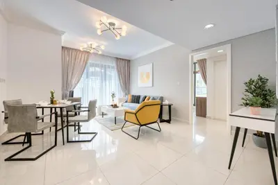 a living room with a table and a dining room at HAVN - NEW 1 Bedroom Apartment in Business Bay in Dubai