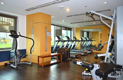 a gym with a bunch of treadmills and machines at HAVN - NEW 1 Bedroom Apartment in Business Bay in Dubai