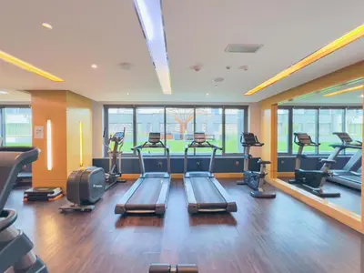 a gym with treadmills and ellipticals in a room at HAVN - NEW 1 Bedroom Apartment in Business Bay in Dubai