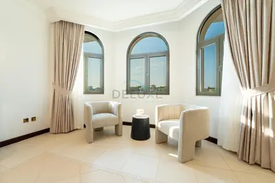 a living room with two chairs and a table at Beachfront 6BR and Assistant's Room Villa with Private Pool, Palm Villa, Palm Jumeirah by Deluxe Holiday Homes in Dubai