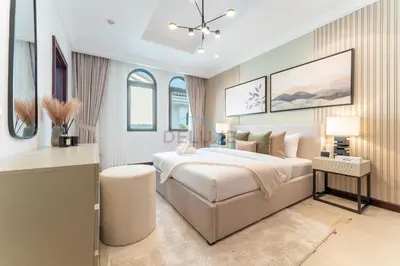a bedroom with a king sized bed and a desk at Beachfront 6BR and Assistant's Room Villa with Private Pool, Palm Villa, Palm Jumeirah by Deluxe Holiday Homes in Dubai