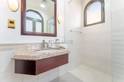 a bathroom with a sink and a mirror at Beachfront 6BR and Assistant's Room Villa with Private Pool, Palm Villa, Palm Jumeirah by Deluxe Holiday Homes in Dubai