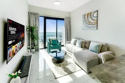a living room with a couch and a chair at Chic 1 BR with Port Views in Dubai