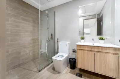 a bathroom with a shower and a toilet and a sink at Chic 1 BR with Port Views in Dubai