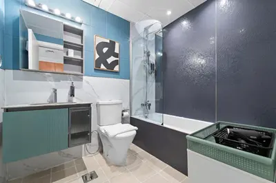 a bathroom with a toilet and a sink and a shower at Modern Studio in Production City in Dubai