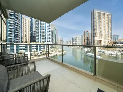 a balcony with a view of a river and buildings at Waterfront Dubai Marina 3-Bedroom Sanctuary in Dubai