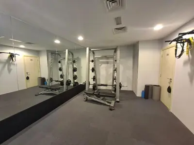a gym with two treadmills and a mirror at Al Bateen - Two Bedroom in JBR with City Views in Dubai