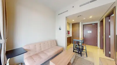 a living room with a couch and a table at Reva Residences - Cosy One Bedroom in Business Bay in Dubai