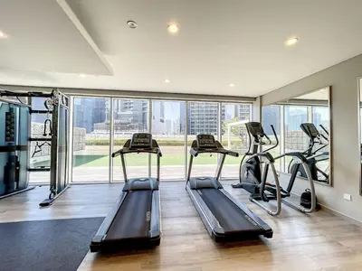 a gym with treadmills and ellipticals in a building at Reva Residences - Cosy One Bedroom in Business Bay in Dubai