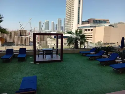 a patio with chairs and a table on a roof at Stylish1BHK in Elite Residences, Marina with View in Dubai