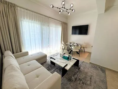 a living room with a couch and a table at Holiday Homes by DO- The Zumrud in Dubai