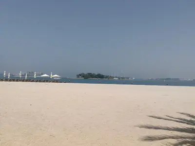 a sandy beach with a view of the ocean at Bright 2 Bedroom Apartment, Beach & Pool Access in Dubai