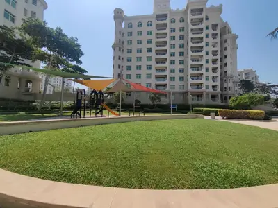 a park in front of a large building at Bright 2 Bedroom Apartment, Beach & Pool Access in Dubai
