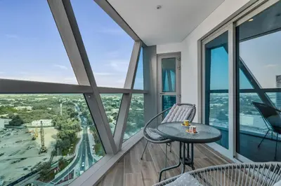 a table and chairs in a room with windows at GuestReady - Upscale living near Downtown Dubai in Dubai