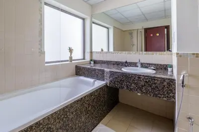 a bathroom with a tub and a sink at GuestReady - Contemporary Apt in JBR in Dubai
