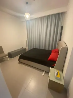 a small bedroom with a bed with a red pillow at 2Bedroom Apartment for Rent Fully Furnished ,Spacious in Dubai