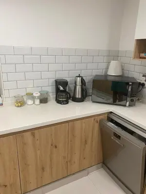 a kitchen counter with a stove and a microwave at 2Bedroom Apartment for Rent Fully Furnished ,Spacious in Dubai