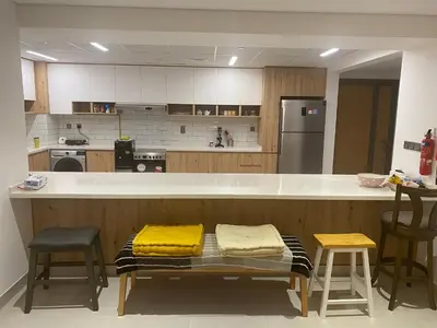 a kitchen with a counter with two yellow pillows on it at 2Bedroom Apartment for Rent Fully Furnished ,Spacious in Dubai