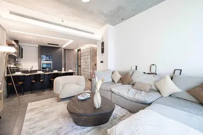 a living room with a couch and a table at 1-Bedroom Apartment with Greenery & City Views in The Terraces in Dubai
