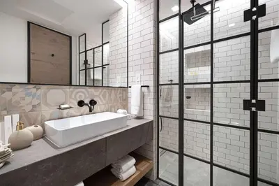 a bathroom with a sink and a large mirror at 1-Bedroom Apartment with Greenery & City Views in The Terraces in Dubai