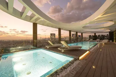 a pool on the roof of a building with a view at Spacious 1BR with Modern Amenities in Westwood Grande JVC in Dubai