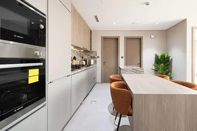 a kitchen with a counter and a stove top oven at Spacious 1BR with Modern Amenities in Westwood Grande JVC in Dubai