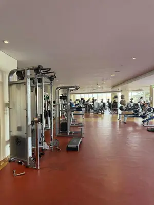a gym with several tread machines and people working out at TYS EXCELLENCE luxury apartment Palm Jumeirah DUBAI in Dubai