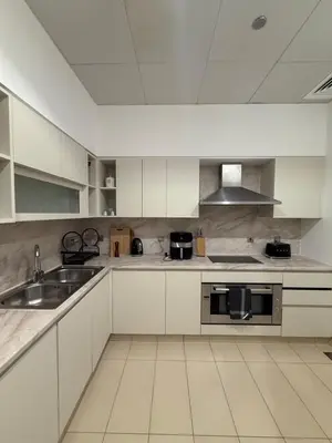 a white kitchen with a sink and a stove at TYS EXCELLENCE luxury apartment Palm Jumeirah DUBAI in Dubai