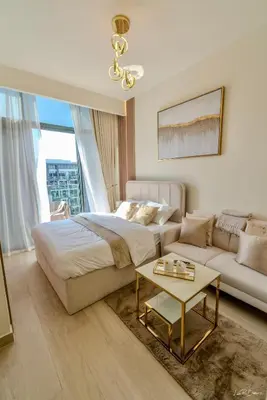 a bedroom with a bed and a couch and a table at Burj Khalifa View studio in Dubai
