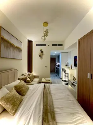a bedroom with a large bed and a living room at Burj Khalifa View studio in Dubai