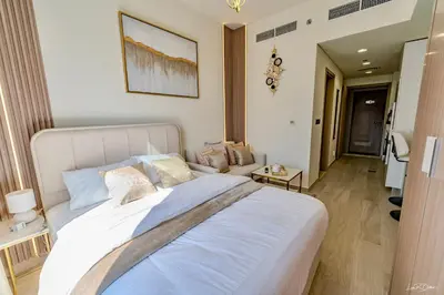 a bedroom with a large white bed in a room at Burj Khalifa View studio in Dubai